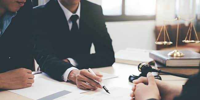 Lawyer and attorney having team meeting at law firm.
