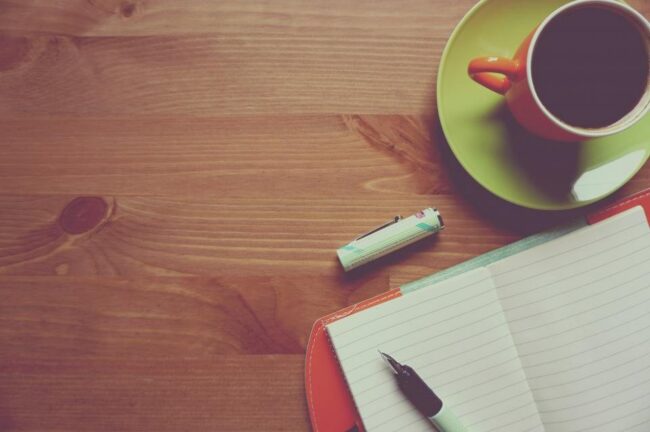 Notebook and coffee cup