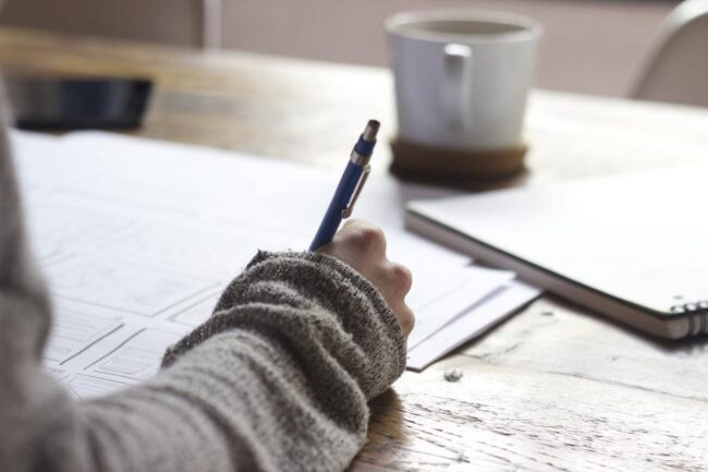 Writing notes at desk