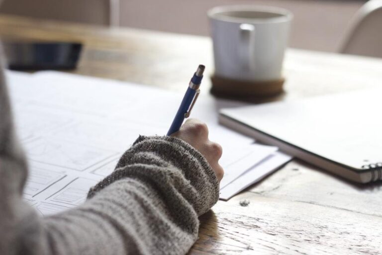 Writing notes at desk